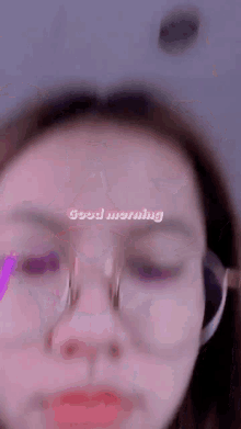 a woman wearing glasses says good morning in pink