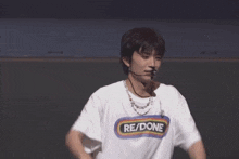 a man is wearing a white t-shirt that says re/done