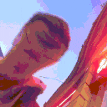 a pixelated image of a person standing in front of a red building