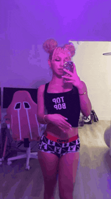 a woman taking a picture of herself in a mirror with a shirt that says 90t bob on it