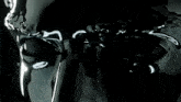 a close up of a person 's face with black eyes