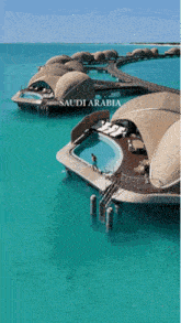 an aerial view of saudi arabia with a swimming pool in the middle of the ocean