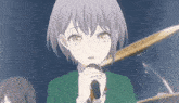 a girl in a green suit is holding a microphone in front of her face .