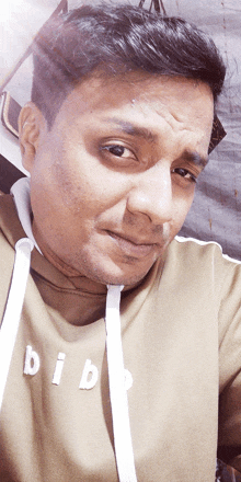 a man is wearing a bib sweatshirt and making a funny face
