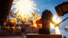 a lego figure is standing in front of fireworks