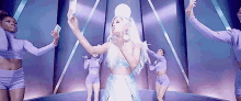 ariana grande is taking a selfie in front of a group of female dancers .
