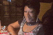 a woman is sitting in a chair with a tiktok watermark