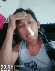 a man with a thermometer in his nose is laying down
