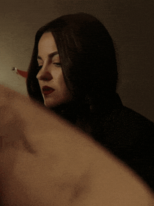 a close up of a woman 's face with a reflection of her face in a mirror