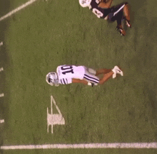a football player wearing a number 11 jersey is running on the field