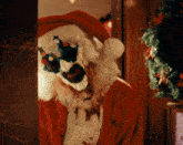 a person dressed in a santa claus costume with a skull on their face