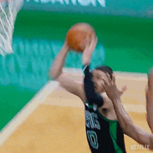 a basketball player with the number 8 on his jersey is shooting a ball