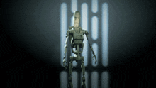 a robot is standing in front of a wall with a few lights behind it