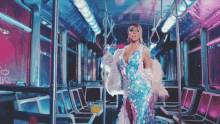 a woman in a sequined dress is standing on a bus