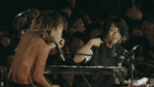 a man playing a keyboard with the letter d on the bottom