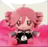 a stuffed doll is sitting on a pink blanket .
