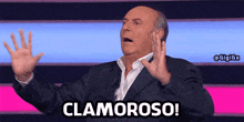 a man in a suit is saying clamoroso with his hands in the air