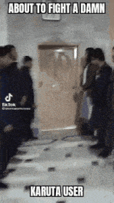 a group of people are standing in front of a door and talking to each other .