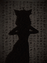 a blurred image of a hand reaching out towards a light bulb