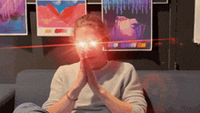 a person sitting on a couch with their eyes glowing brightly