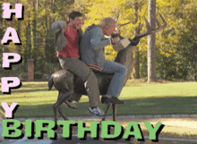 two men riding on the back of a statue of a deer with the words happy birthday