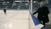a hockey game is being played in a stadium and the score is 2 to 1
