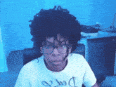 a man wearing glasses and a t-shirt with a dollar sign on the front