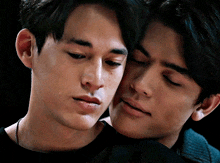 a close up of two men 's faces with one of them crying