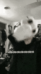 a black and white photo of a person wearing a black sweater with the words " няняняняняня " on the bottom left