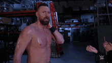 a man without a shirt is being punched in the face by another man
