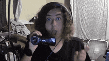 a man wearing headphones holds a 4k camera