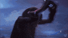 a blurred image of a person in a dark room with a xbox logo in the corner