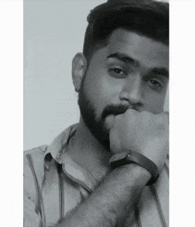 a black and white photo of a man with a beard