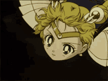 a close up of a cartoon character 's face with a crown on her head