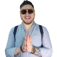 a man wearing sunglasses and a blue shirt with suspenders is clapping his hands