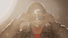 a man wearing a hat and sunglasses has a microphone in his ear
