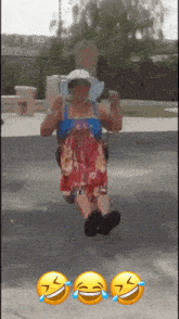 a woman in a dress is sitting on a swing with three smiley faces on the ground behind her