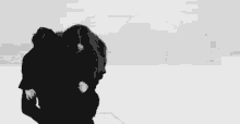 a black and white photo of a man carrying a woman on his shoulders in the snow .