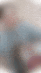 a blurry picture of a person 's torso with a blue shirt on