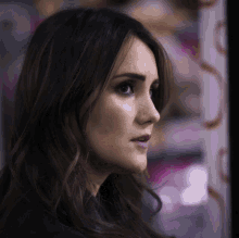 a close up of a woman 's face with long hair