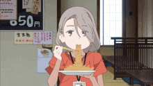 a girl eating noodles with chopsticks in front of a sign that says 50