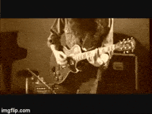 a man with a beard is playing a guitar in a sepia tone