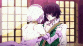 a man and a woman are hugging in a room