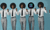 a group of men wearing plaid pants and white shirts are standing in a row with one wearing a coin on his head