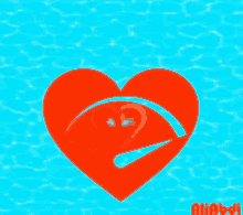 a red heart is floating in a pool of water