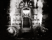 a black and white photo of a group of people standing in front of a building with smoke coming out of it