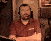 a man wearing a headset and a red shirt that says king on the front