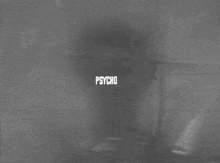 a black and white photo of a woman in a shower with the words psycho behind her