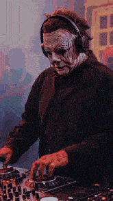 a man in a mask is playing music on a mixer