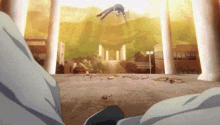 a man is flying through the air in front of a building in a city .
